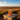 AI gegeneerd beeld van een veld rooibosstruiken met een doosje Twinings Rooibos op een stenen plateau.